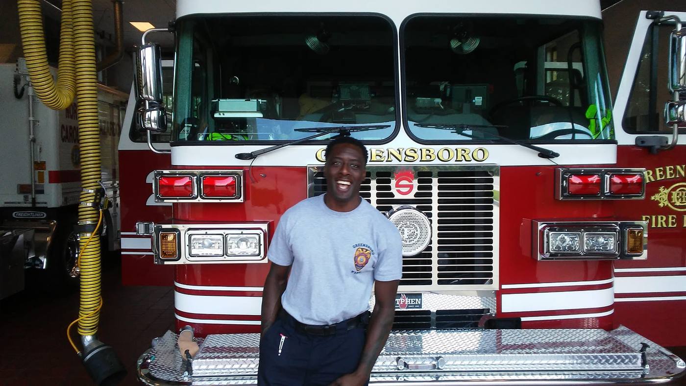 Lamar W. Sullivan in front of a Greensboro Fire Department engine