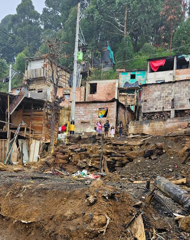 Debris and burned material on a hillside site in Medellin